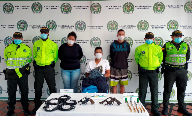 3 personas capturadas- policías custodiando-armas de fuego y munición incautada